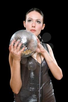 Portrait of young brunette with a mirror ball in her hands. Isolated on black