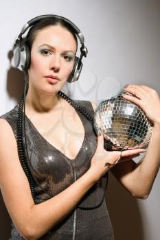 Portrait of brunette with a mirror ball in her hands
