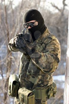 Portrait of soldier with a handgun in his hands