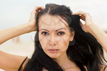 Closeup portrait of a young woman on the beach
