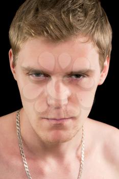 Closeup portrait of a suspicious young man. Isolated