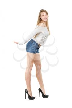 Pretty playful woman wearing blue jeans shorts, white blouse and black shoes. Isolated