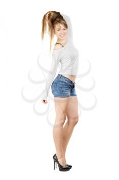 Young smiling woman demonstrating her healthy hair and slim figure. Isolated on white