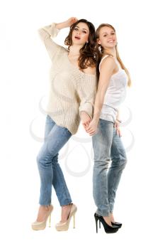Attractive caucasian women posing in blue jeans and high heels. Isolated on white