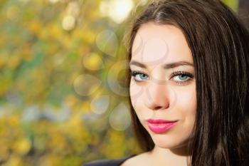 Portrait of thoughtful young lady with straight black hair