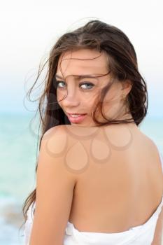 Portrait of sexy smiling young brunette posing outdoors
