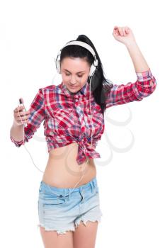 Portrait of young brunette dancing in headphones. Isolated on white