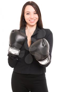 Portrait of young brunette wearing black jacket and boxing gloves. Isolated on white