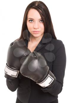 Portrait of young brunette wearing black boxing gloves. Isolated on white