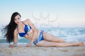 Alluring young brunette posing on the beach