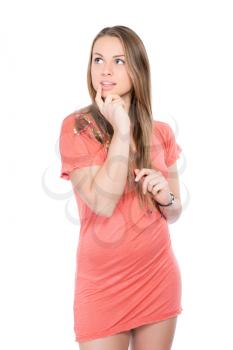 Portrait of pensive young woman in pink dress. Isolated on white