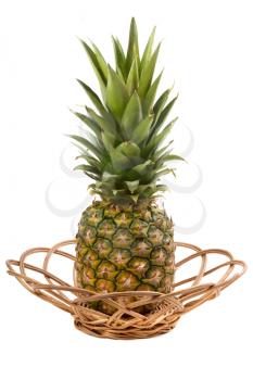 Close-up of sweet pineapple in wicker. Isolated