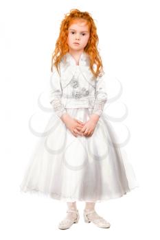 Little redhead girl posing in nice white dress. Isolated
