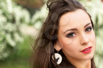 Portrait of young pretty brunette with tousled hair