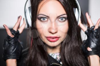 Young brunette listening to music with eyes wide open