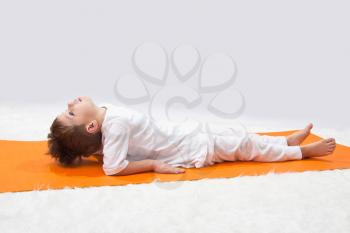Royalty Free Photo of a Little Boy Doing Yoga