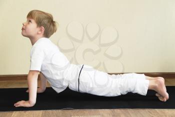 Royalty Free Photo of a Little Boy Practicing Yoga