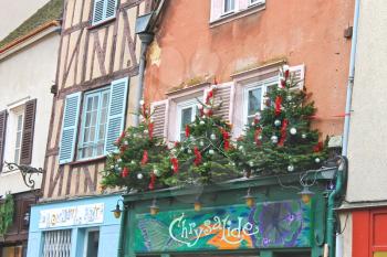 Decorative Christmas trees on a house facade in Chartres, France