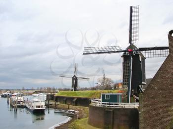 Ships and windmills in the port city Heusden. Netherlands