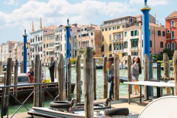 VENICE, ITALY - MAY 06, 2014: People on quay of the Grand Canal  in sunny spring day,Venice, Italy