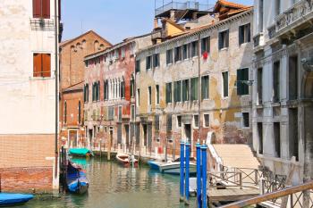 Houses and boats on one of the canals in Venice, Italy