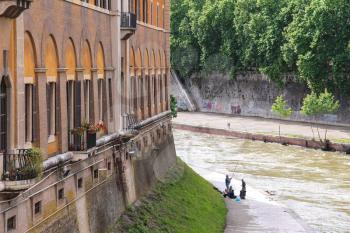 ROME, ITALY - MAY 03, 2014: Fishermen on the bank of the river Tiber  in Rome, Italy