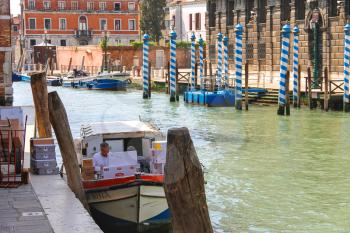 VENICE, ITALY - MAY 06, 2014: Service worker unloads delivery products for the restaurant and hotel in Venice, Italy