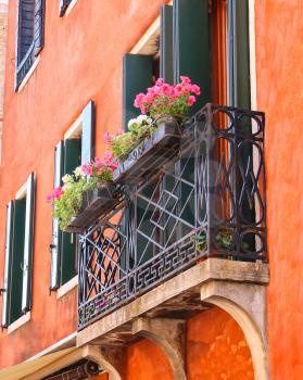 Picturesque balcony with flowers in an old Italian house