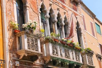 Picturesque Italian house with flowers on the balconies 