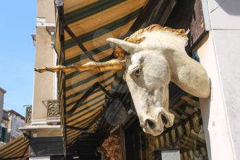 Unicorn head on the facade of a building in Venice, Italy