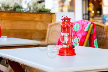 The red lamp stands on a table outdoor cafe