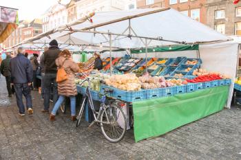 Den Bosch, Netherlands - January 17, 2015: People near vegetable stalls on the market square  in  Dutch town Den Bosch.