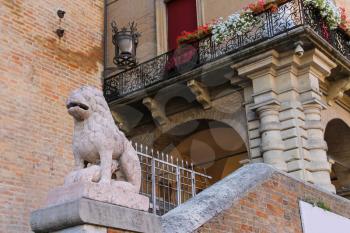 Ancient building with old stone statue on Cavour square in Rimini, Italy