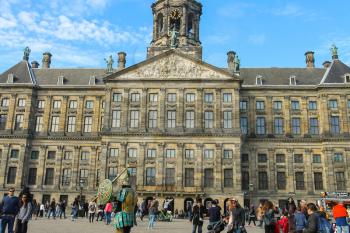 Amsterdam, the Netherlands -October 03, 2015: Tourists walking next to the Royal Palace on Dam Square