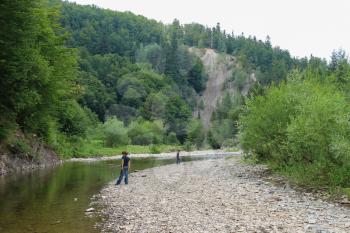 Two boys near mountain river in Carpathians, Ukraine