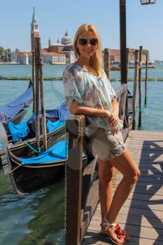 Pretty woman with long blond hair in Venice, Italy