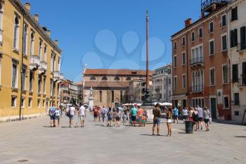 Venice, Italy - August 13, 2016: Tourists walking on St. Stephen's square (campo Santo Stefano)