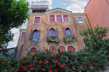 Picturesque house with flowers in historic centre of Venice, Italy