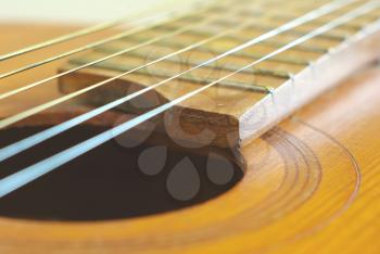 Old wooden string guitar closeup. Vintage acoustic music background. Musical classical instrument.