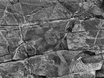 
black and white stone rock with cracks in the background