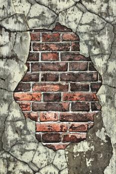 old brick wall with crumbling plaster cracked