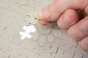 Royalty Free Photo of a Person Doing a Puzzle