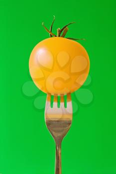 Royalty Free Photo of a Tomato on a Fork