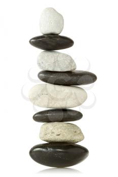 Balanced stone tower over a white background