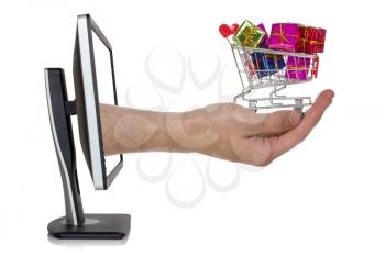 Computer screen and hand with shopping cart full of gifts