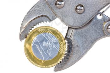Euro crisis concept - euro coin squeezed in an  pliers, isolated on white background