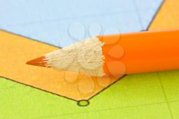 orange pencil on the colorful paper background