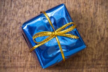 Blue gift box on the wooden background