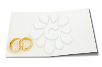 Wedding rings on the card for text over a white background