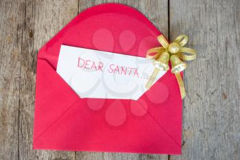 Royalty Free Photo of a Letter to Santa in an Envelope With a Christmas Decoration